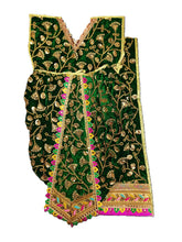 Load image into Gallery viewer, A dark green velvet traditional garment with extensive gold zari embroidery, featuring a V-neckline, flared waist, and a decorative border with pink and multicolor accents, shown against a plain white background.
